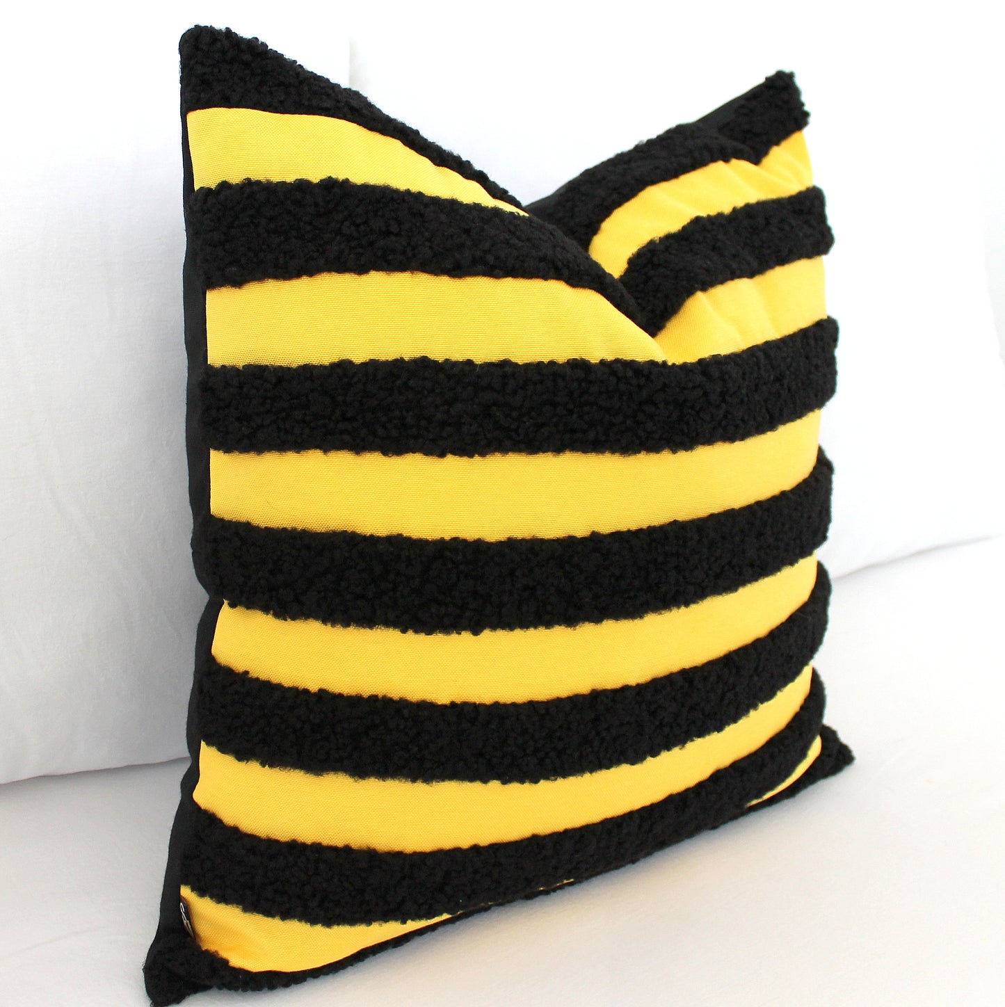 Black and Yellow Boucle Teddy Textured Throw Pillow Cover. Its playful texture and bold bee-inspired colors add a quirky twist to classic style. Bee different and add this unique, cheerful accent to your decor!