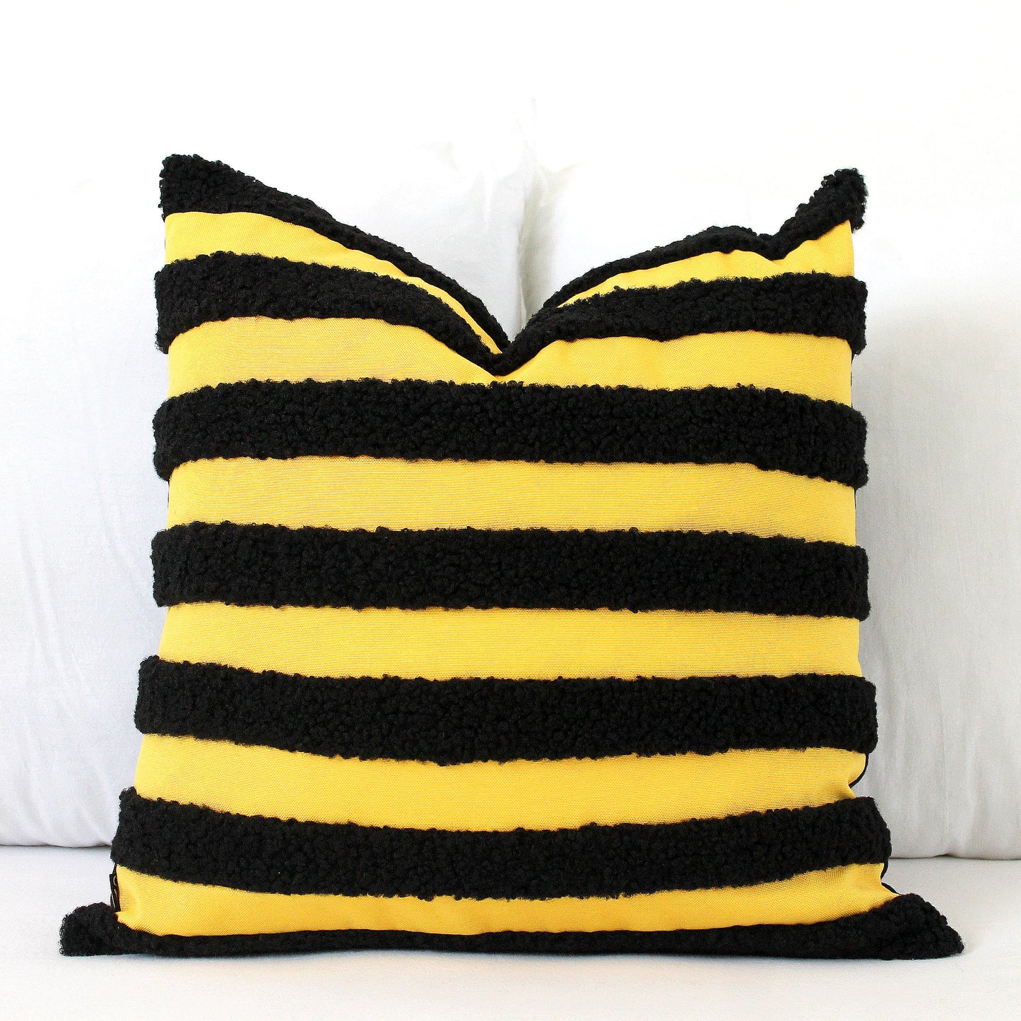 Bring a buzz of fun to your home with this Black and Yellow Boucle Teddy Textured Throw Pillow Cover. Its playful texture and bold bee-inspired colors add a quirky twist to classic style. Bee different and add this unique, cheerful accent to your decor!