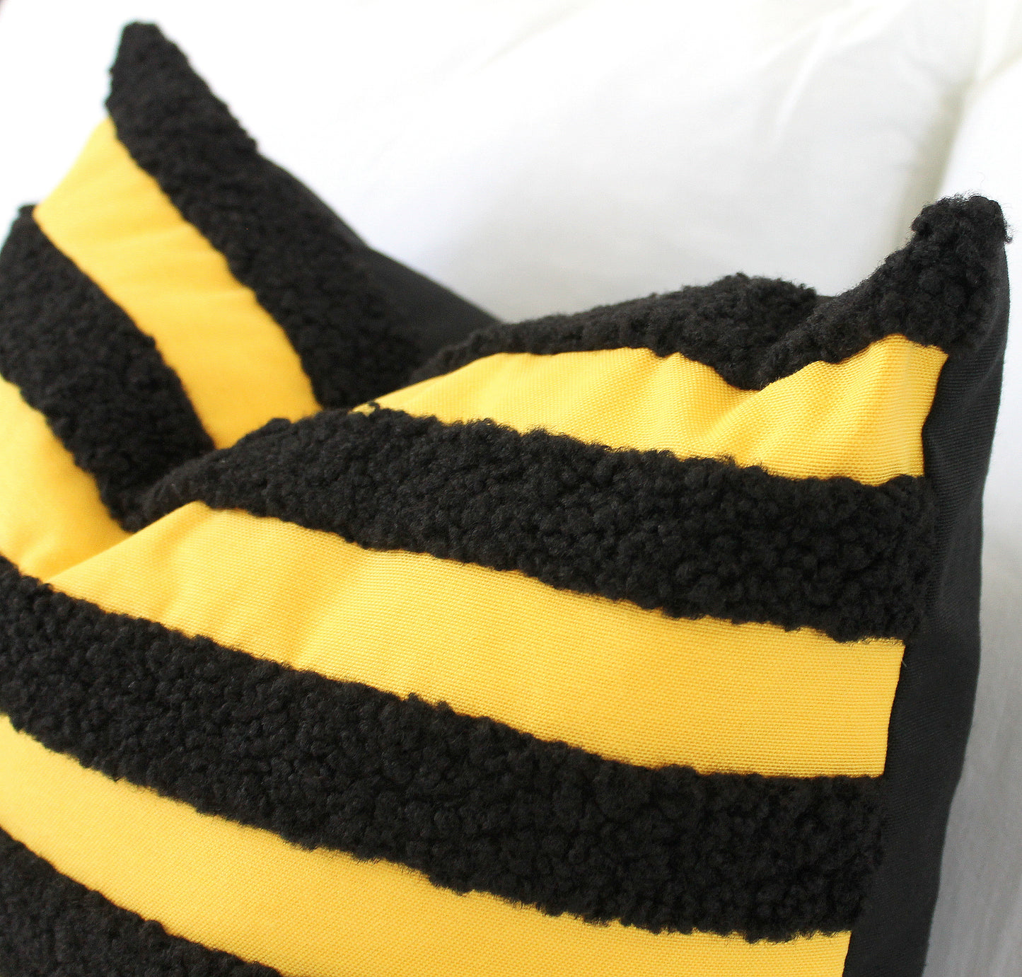 Black and Yellow Boucle Teddy Textured Throw Pillow Cover. Its playful texture and bold bee-inspired colors add a quirky twist to classic style. Bee different and add this unique, cheerful accent to your decor!