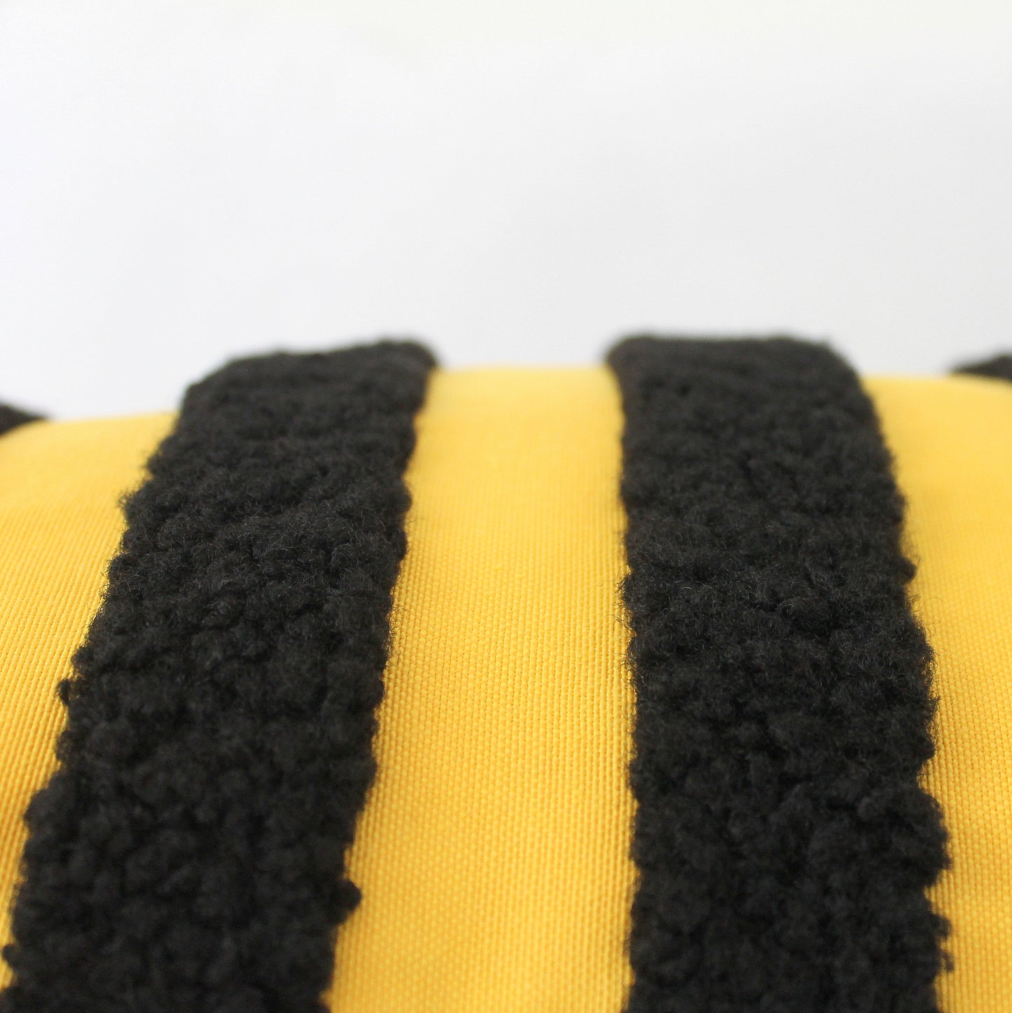 Black and Yellow Boucle Teddy Textured Throw Pillow Cover. Its playful texture and bold bee-inspired colors add a quirky twist to classic style. Bee different and add this unique, cheerful accent to your decor!