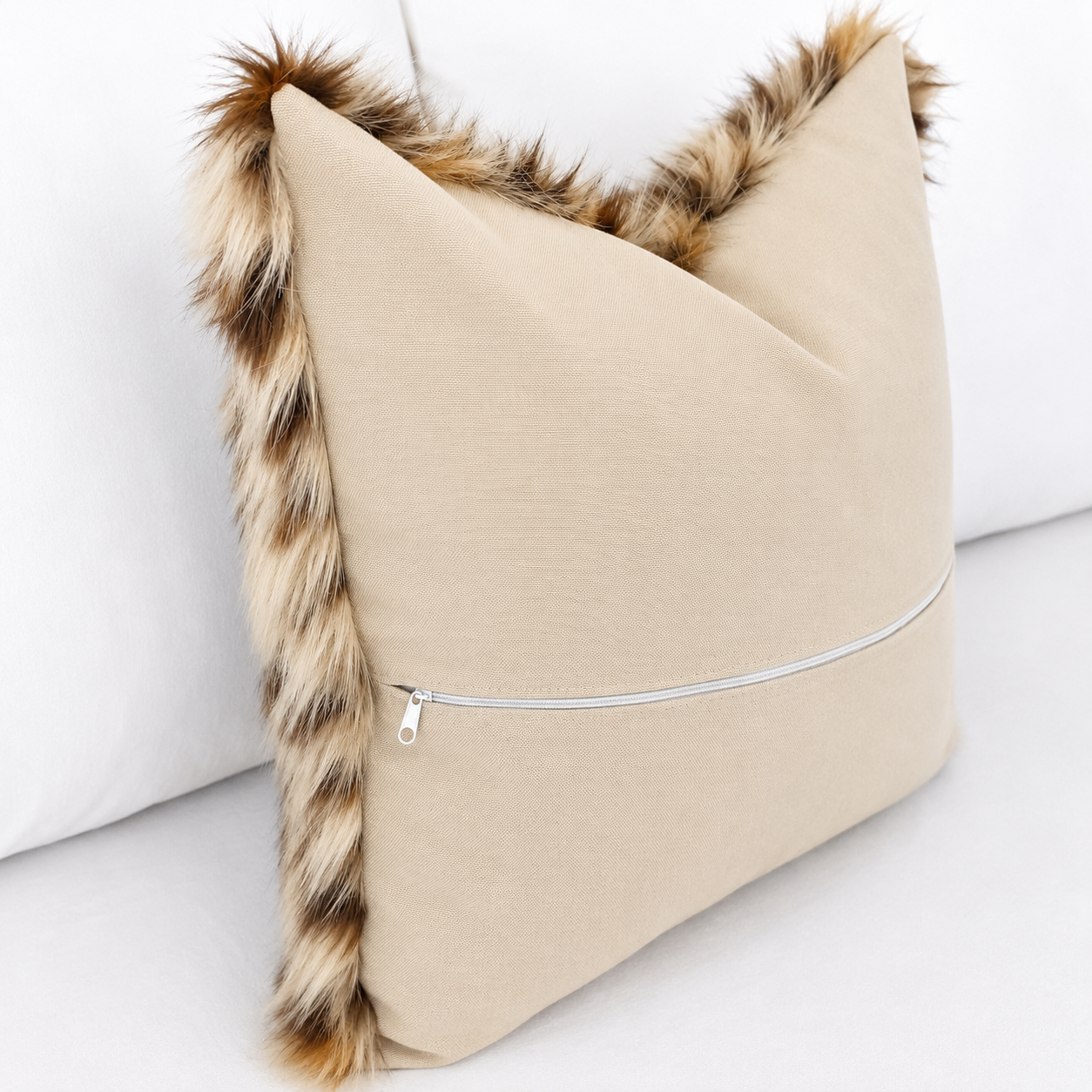 Luxury Leopard Cat faux fur pillow cover with ultra-soft long pile in natural cream, caramel, brown and charcoal tones styled on a white bed.