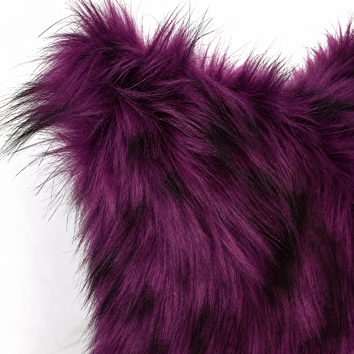 Deep purple faux fur pillow cover with black-tipped long pile, styled on a white sofa for gothic and Halloween home decor
