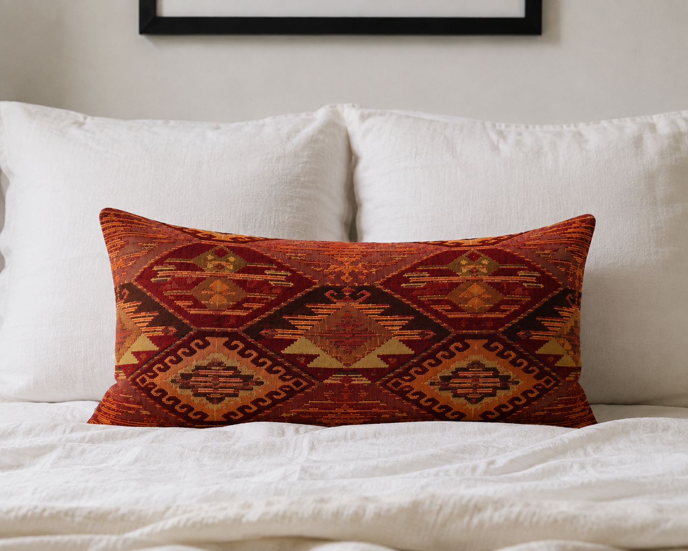 Red rust kilim lumbar pillow cover styled on a white bed