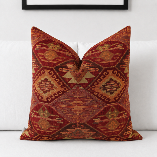 Red rust kilim lumbar pillow cover styled on a white bed