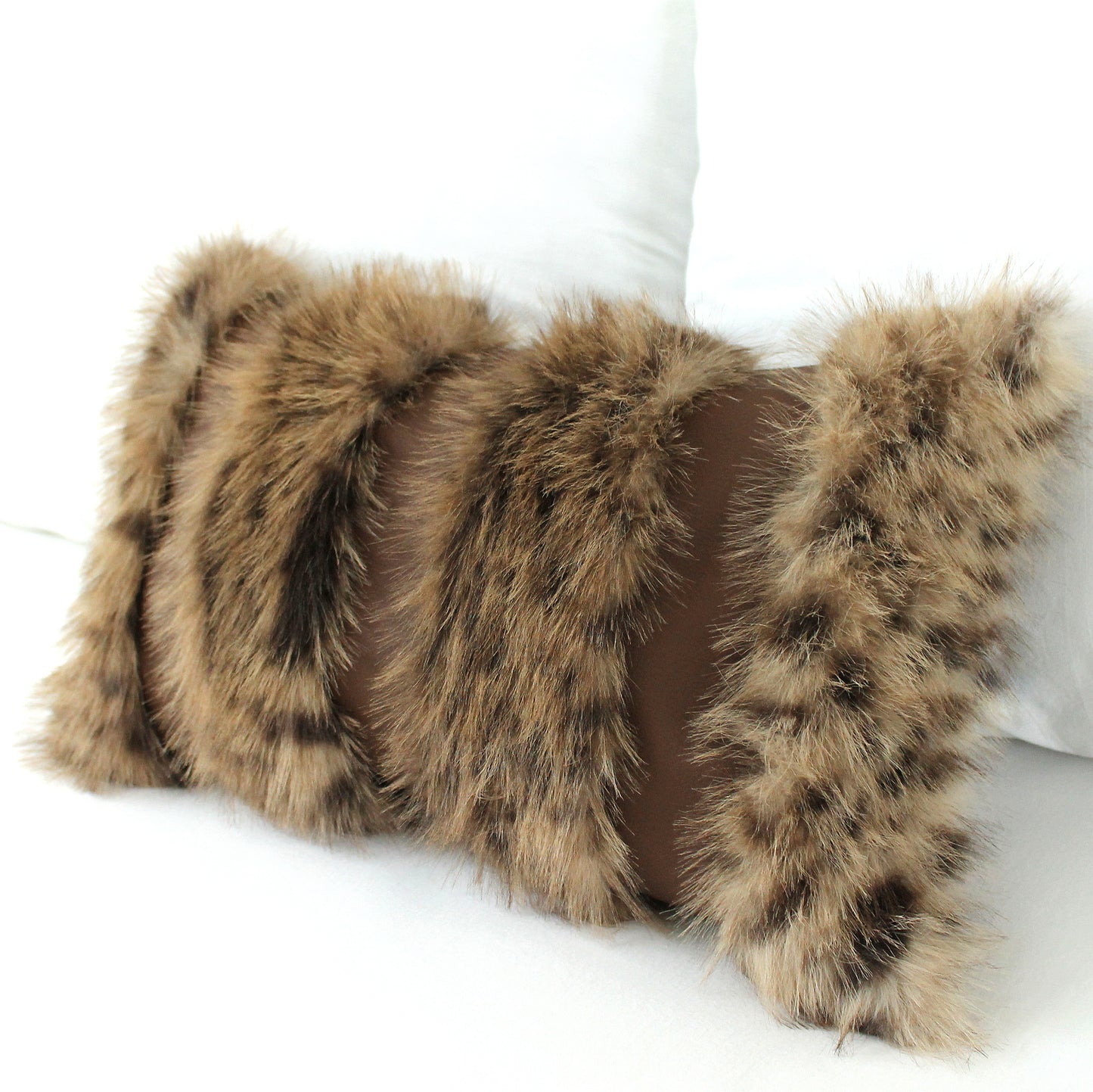 Furry pillow with a brown and black pattern on a white background