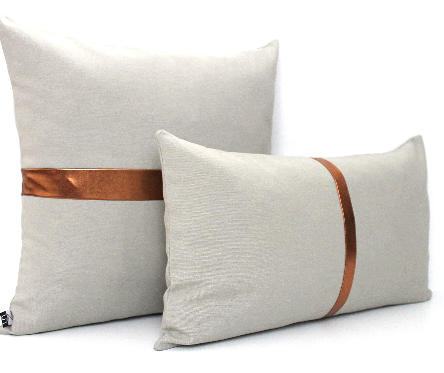 These affordable pillow covers are a must if you are looking for a touch of luxury in your home. The light grey cotton is made to pop with a custom stripe of silver, gold or copper or shiny black.